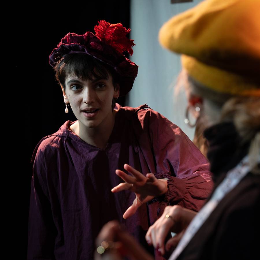 Orlando performer wearing a red feathered hat